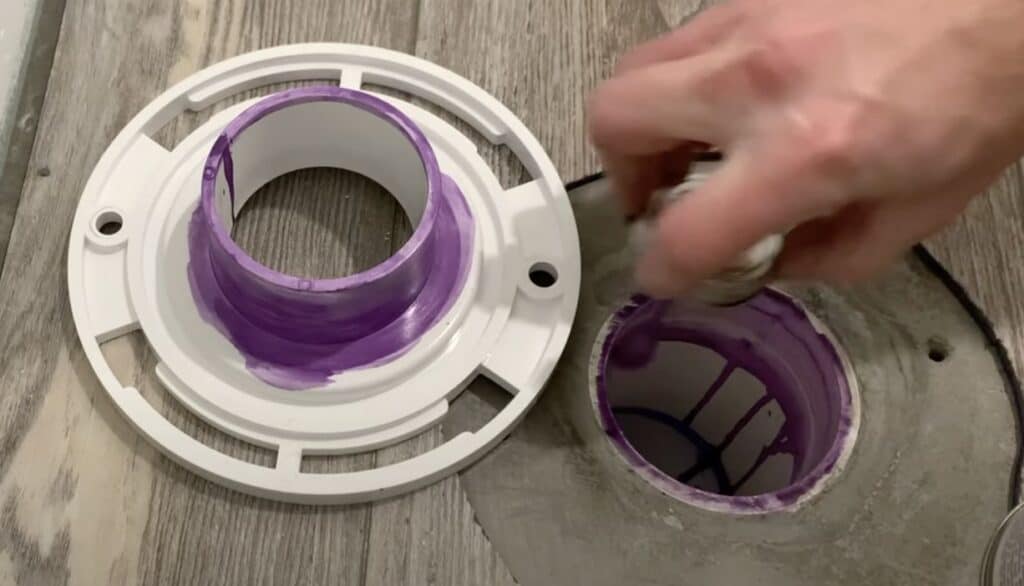 Apply PVC primer and glue to the the toilet flange and PVC drain pipe 